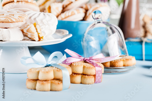 Composition in white and blue with candies, cookies and chocolat