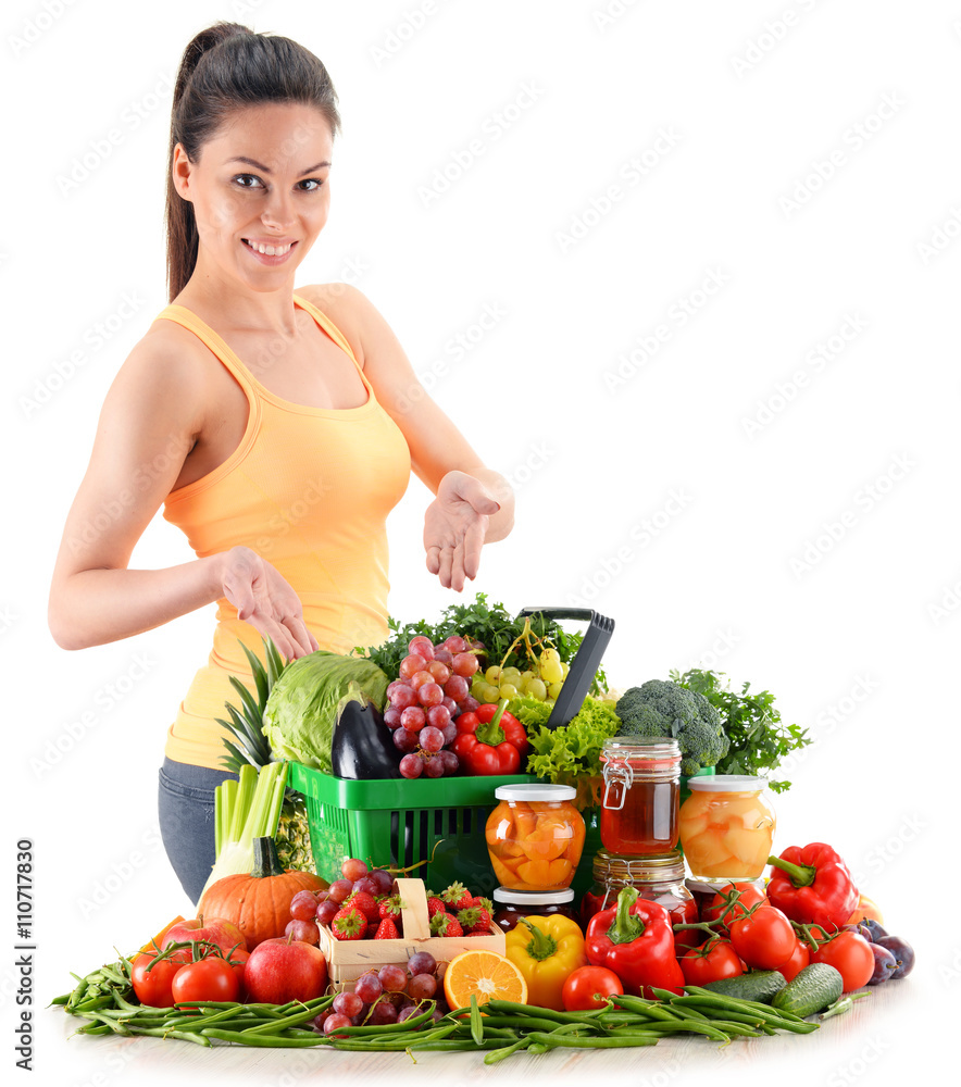Young woman with variety of organic vegetables and fruits Young woman with variety of organic vegetables and fruits