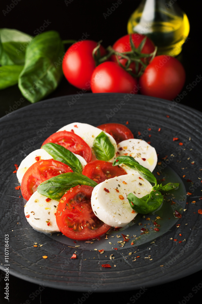 Caprese salad with mozzarella, fresh tomato and basil Caprese salad with mozzarella, fresh tomato and basil