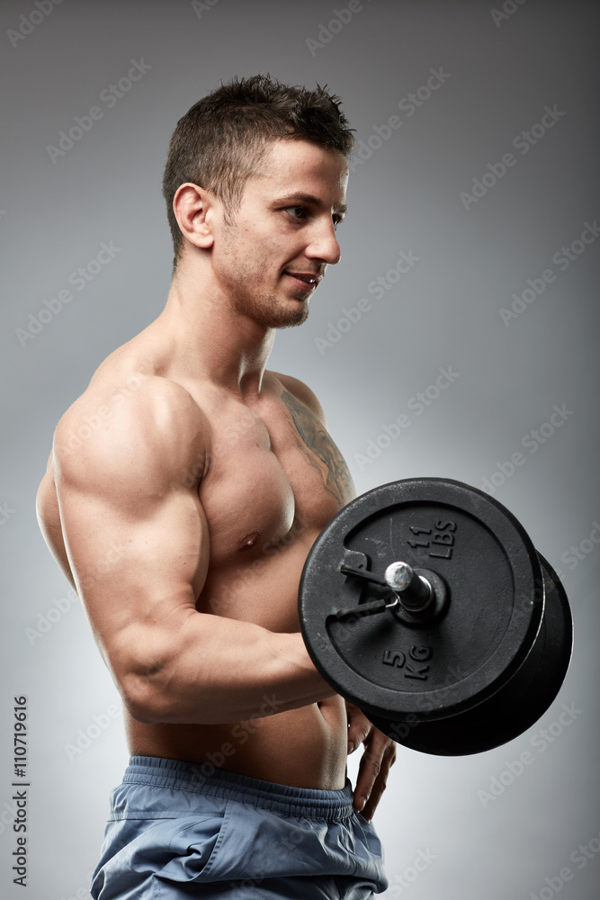 Biceps curl with dumbbell on grey background Biceps curl with dumbbell on grey background