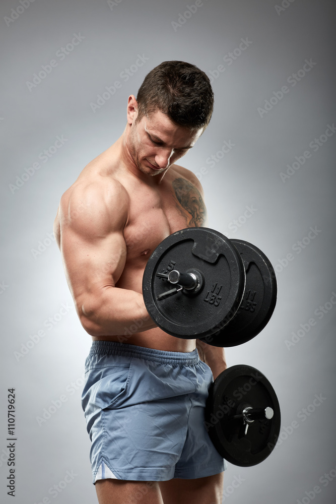 Biceps curl with dumbbell on grey background Biceps curl with dumbbell on grey background