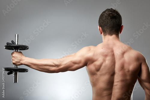 Man doing shoulder workout in studio photo
