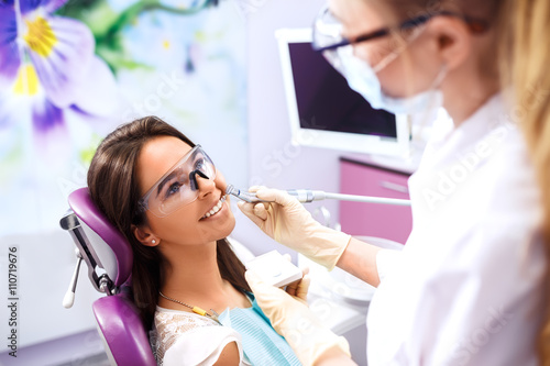 Overview of dental caries prevention.Woman at the dentist s chair during a dental procedure. Beautiful Woman smile close up. Healthy Smile. Beautiful Female Smile  