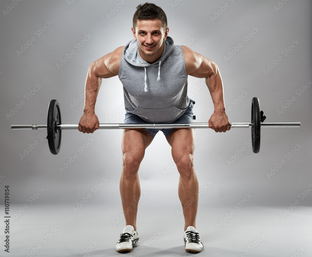 Man doing barbell row in studio Man doing barbell row in studio