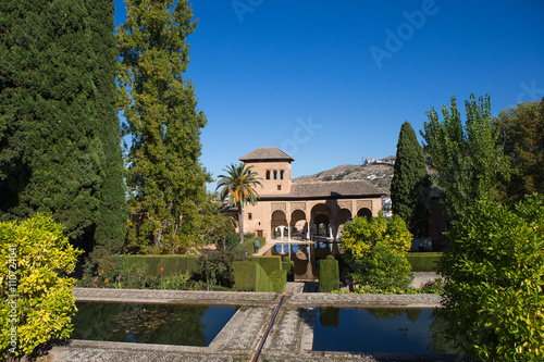 Ladies Tower (Torre de las Damas) and Gardens of the Partal. This moorish building was built in the middle ages in fortress complex Alhambra in Granada. Spain
