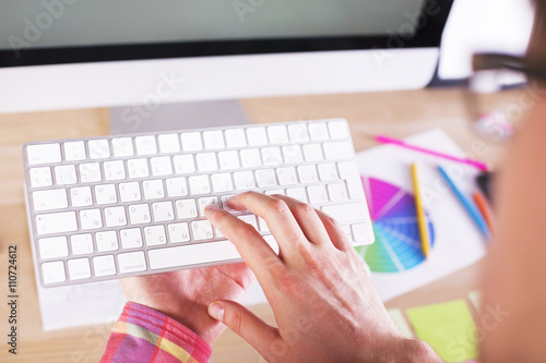 Man holding keyboard and typing