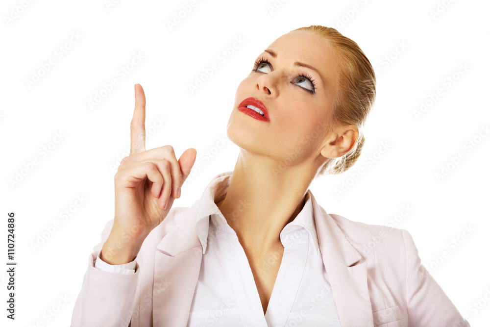 Young smiling business woman pointing up Young smiling business woman pointing up