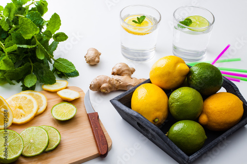 Ingredients for homemade lemonade, view from above. Lemon, lime and mint for refresh water.