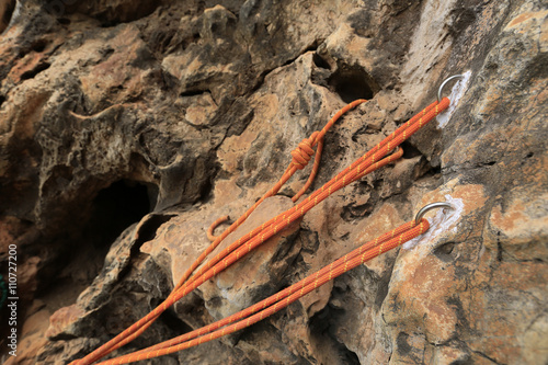 closeup of rock climbing ropes on mountain cliff
