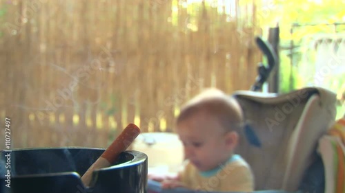 Smoke from a cigarette to the baby
