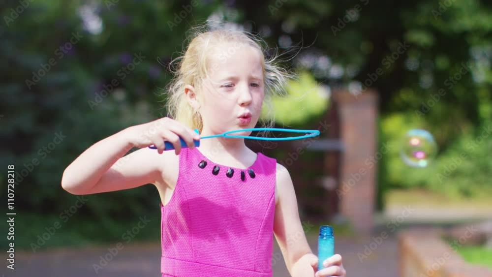 Cute little girl having fun playing with bubbles in the garden Cute little girl having fun playing with bubbles in the garden