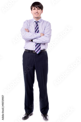 Full length shot of businessman with folded arms.