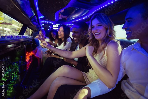 Vászonkép Happy friends chatting in limousine