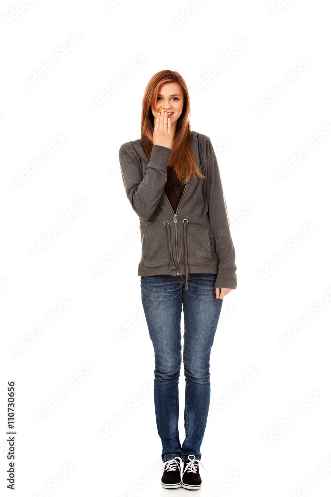 Giggles teenage woman covering her mouth with hand Giggles teenage woman covering her mouth with hand
