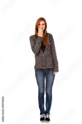 Giggles teenage woman covering her mouth with hand