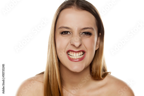 young woman gnash her teeth