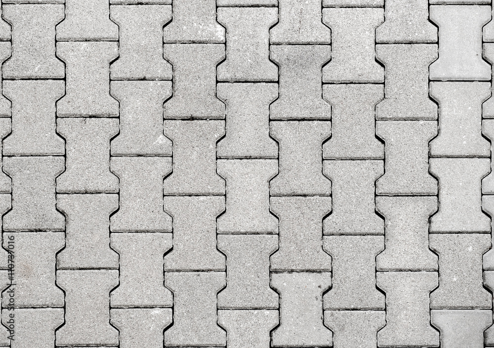 Obraz premium Concrete or cobble gray H Shaped pavement slabs or stones.