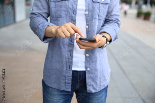 woman hands with smart phone in modern city