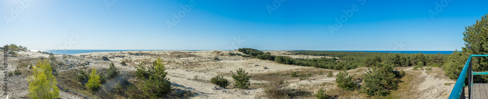 Panorama of sandy dunes and blue sky in the spring morning. Efa Height., Curonian Spit National Park, Russia.