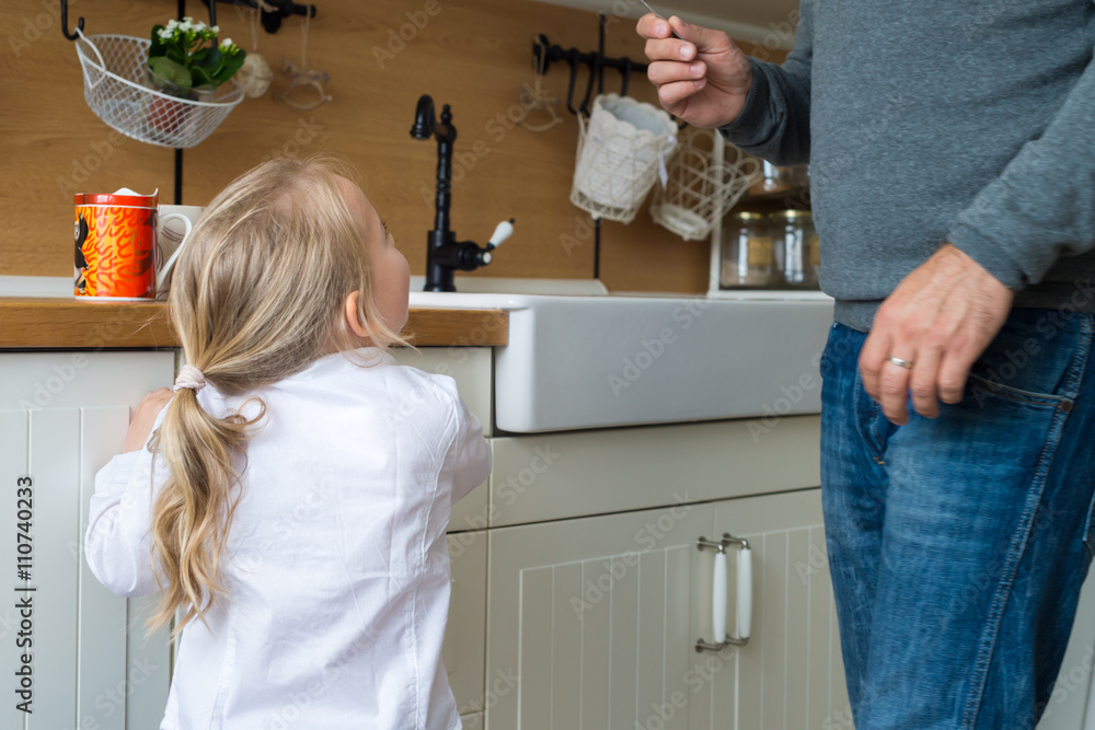 Father and daughter in the kitchen, fathers day concept, real family Father and daughter in the kitchen, fathers day concept, real family