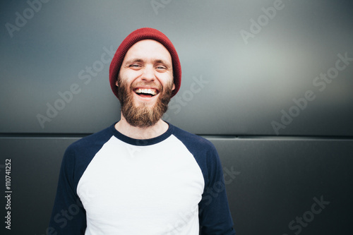 Hipster man smiling and wearing a hat