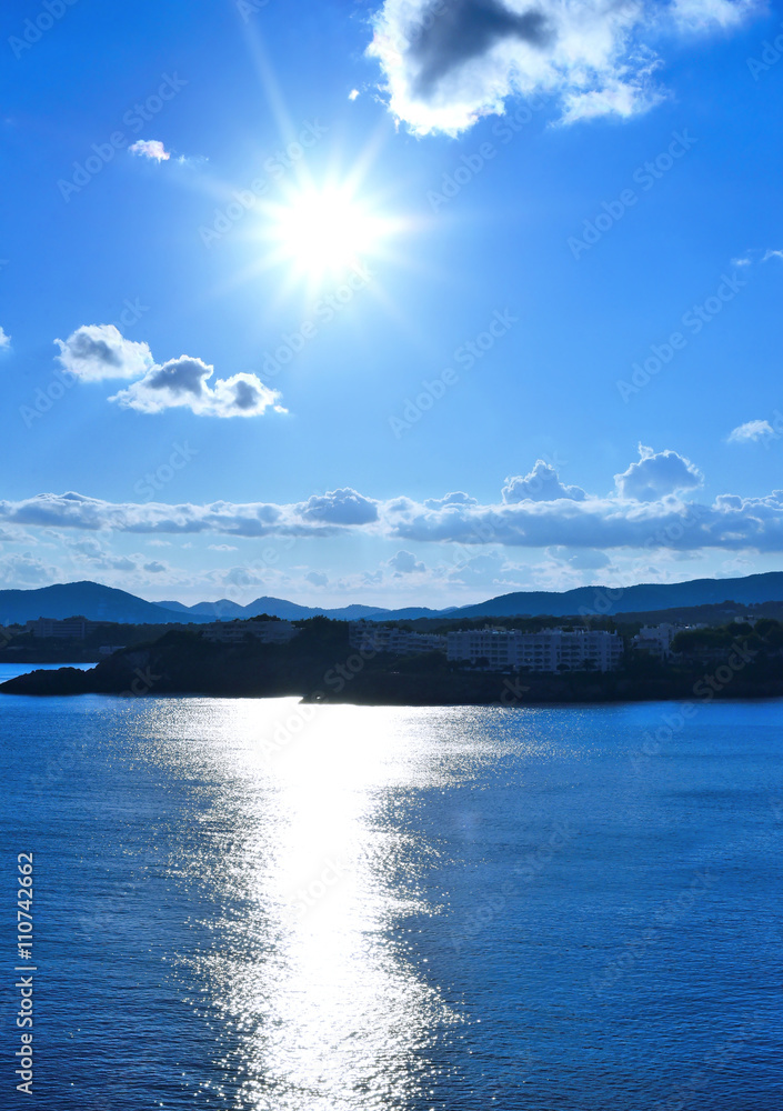 Fototapeta premium sunbeam over an island with copy space and view over the sea. 