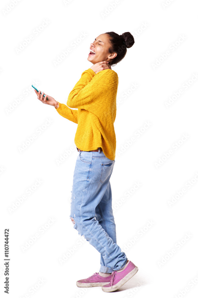 Laughing young woman walking with mobile phone Laughing young woman walking with mobile phone