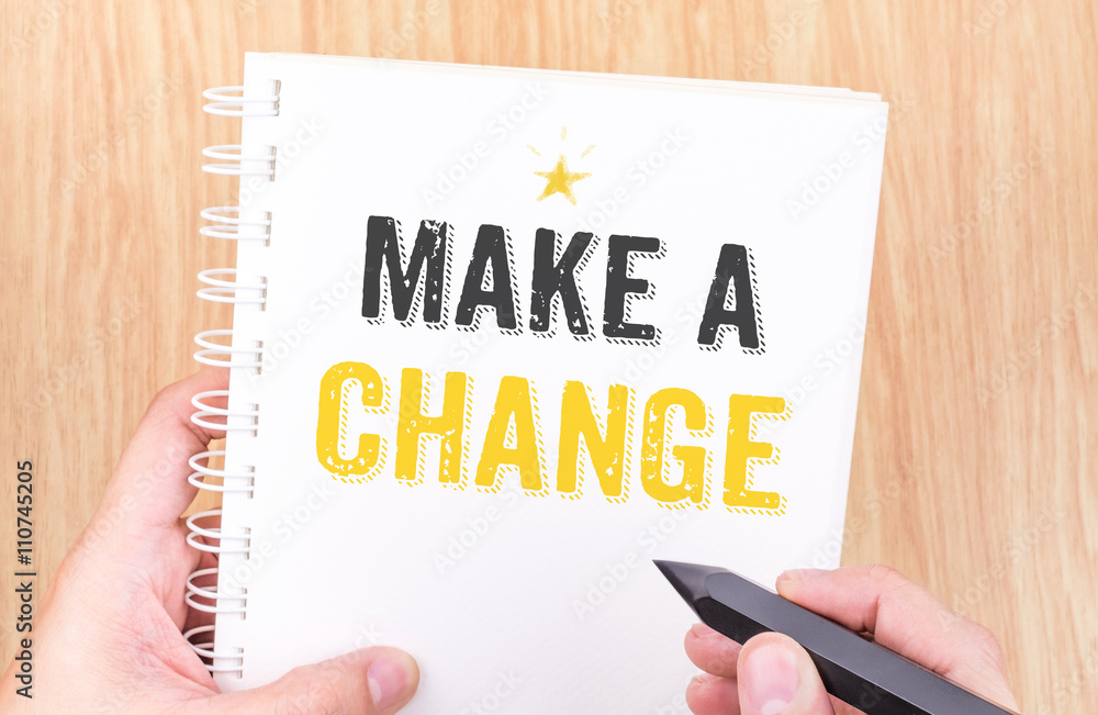 Make a change word on white ring binder notebook with hand holdi Make a change word on white ring binder notebook with hand holdi