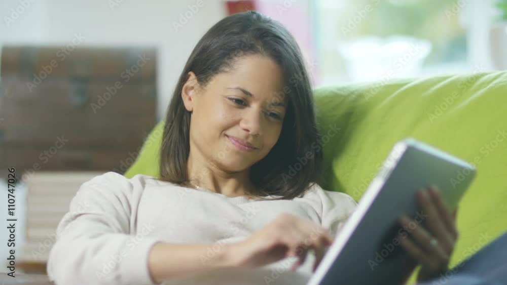 Portrait of smiling pregnant woman relaxing at home with tablet computer Portrait of smiling pregnant woman relaxing at home with tablet computer