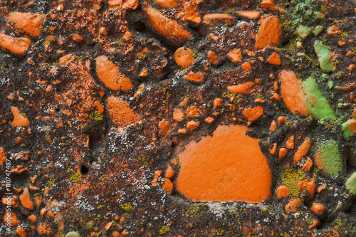 Dirty grey concrete wall with colored stones 3