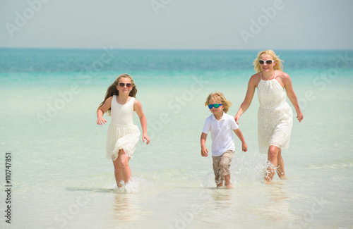 Little girl with family has fun at the beach