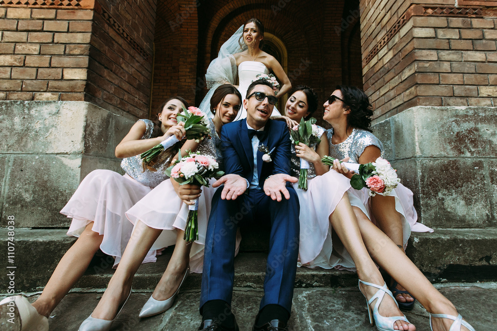 Emotional bride with a groom and the beautiful bridesmaids
