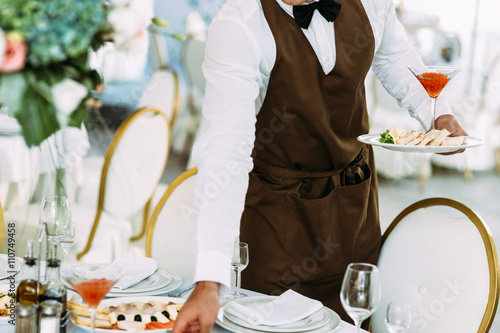 Waiter is serving a wedding table