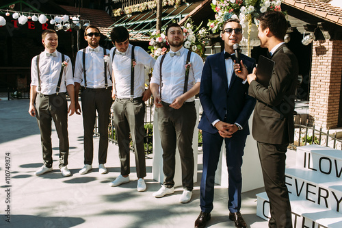 Handsome groom and groomsmen on the wedding ceremony