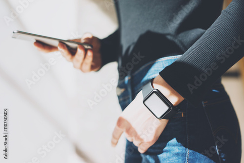 Picture Woman Working Modern studio,Wearing Generic Design Smart Watch.Female Hands Touching screen mobile phone.Manager Work Process. Horizontal mockup. Burred background. Film effects