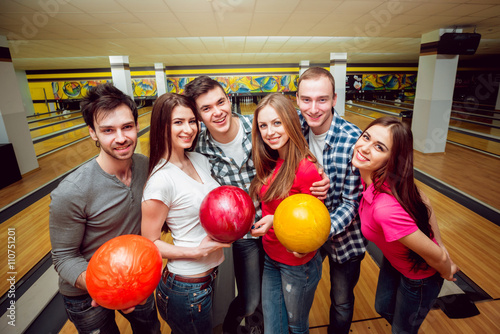 Cheerful friends at the bowling alley