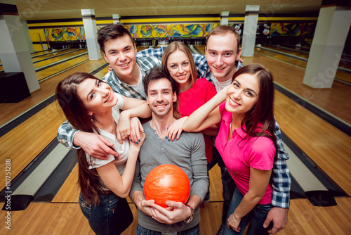Cheerful friends at the bowling alley