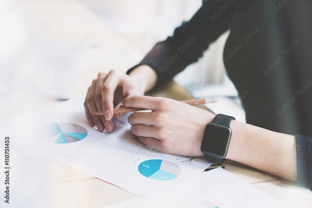 Picture Woman Working Modern Office.Girl Wearing Generic Design Smart Watch.Female Hands holding pencil. Account Manager Work Process at Wood Table.Horizontal mockup.Burred Background. Film effect