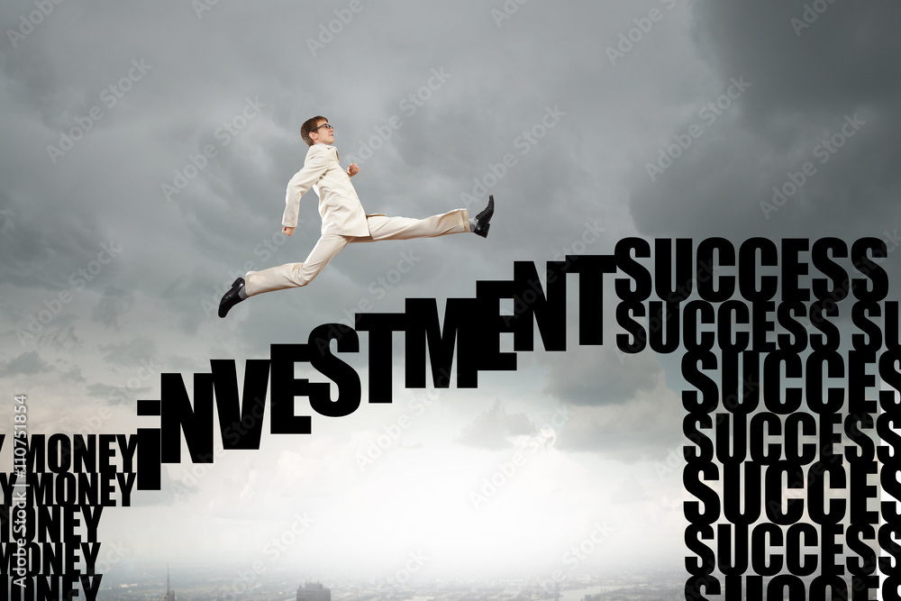 Businessman jumping over gap