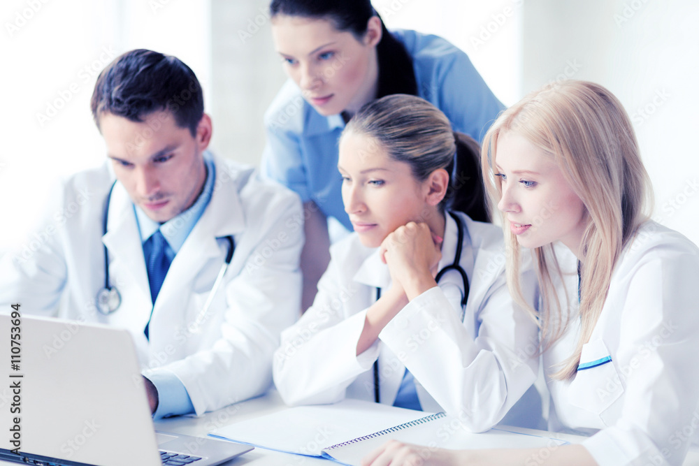 group of doctors looking at tablet pc group of doctors looking at tablet pc