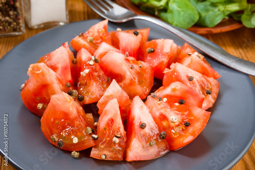 cut tomatoes with oil and pepper