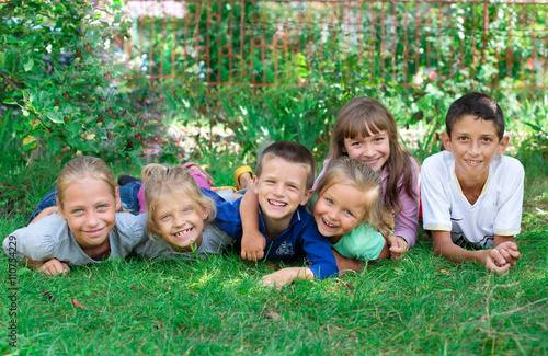 children lying on the grass laughing and having fun