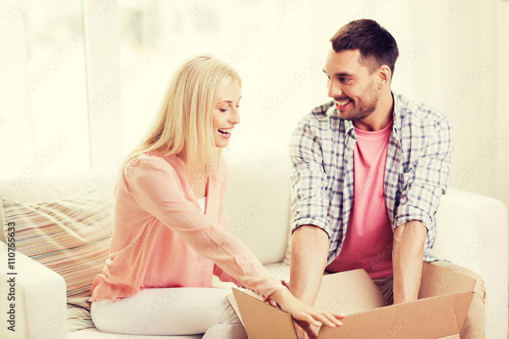 happy couple with open parcel box at home happy couple with open parcel box at home