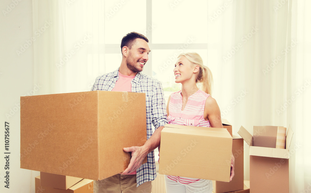 couple with big cardboard boxes moving to new home couple with big cardboard boxes moving to new home
