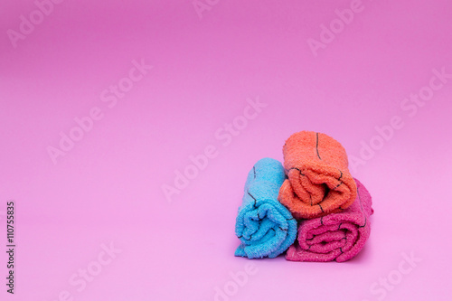 roll of towels on pink background