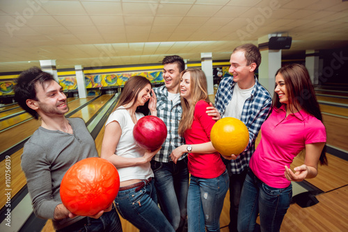 Cheerful friends at the bowling alley