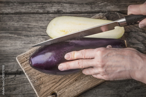 Cutting eggplants  on the wooden board