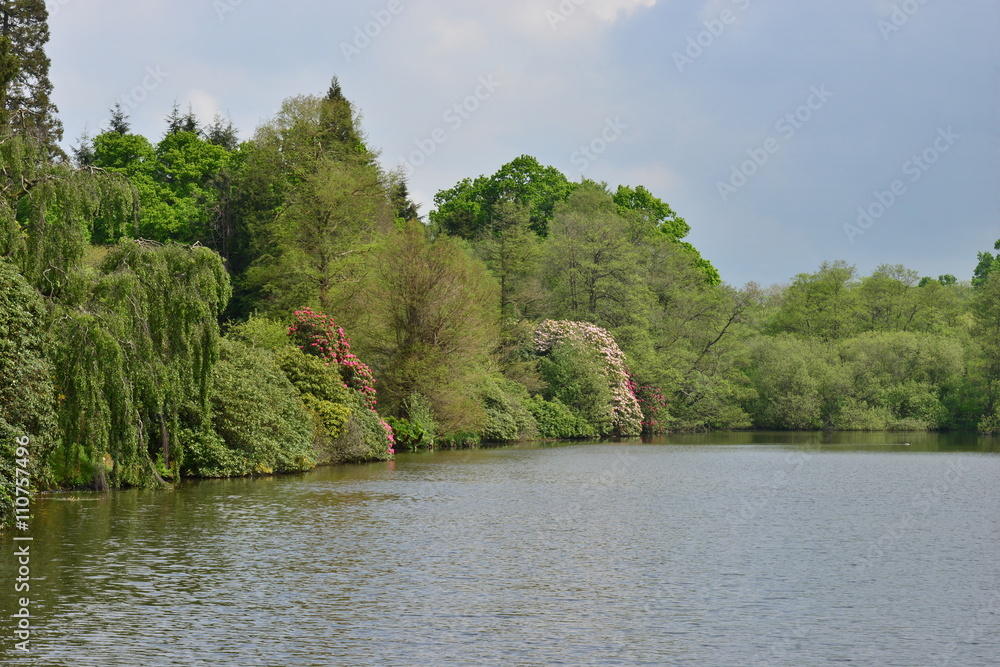 An English country garden with a lake in late springtime. An English country garden with a lake in late springtime.