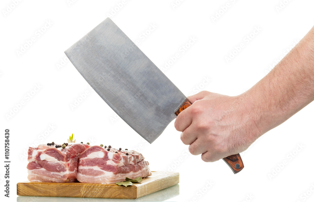 Raw pork meat, cutting board, man's hand holding knife. Raw pork meat, cutting board, man's hand holding knife.