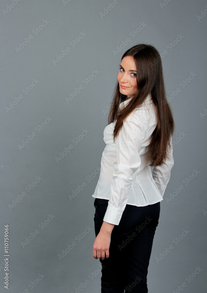 Beautiful young brunette girl standing in white blouse Beautiful young brunette girl standing in white blouse